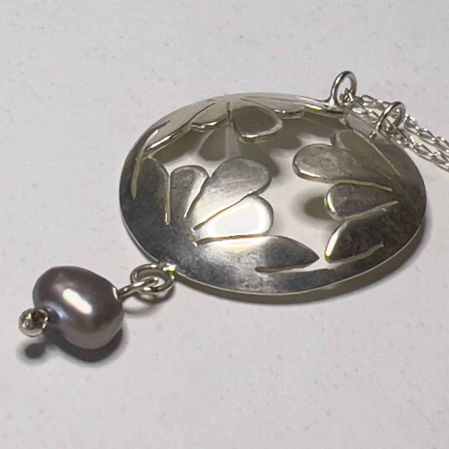 Silver and pearl motif necklaces